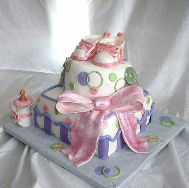 Whimsical Baby Shower Cake in Pink, Green, and Purple with Edible Gumpaste baby Shoes, Baby Bottle, and Safety Pins view 1