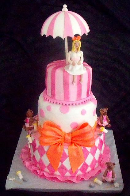 Baby Shower Fondant Cake with Mother Figurine, Umbrella, Princess Bears, Baby Bottles, Harlequin Design, Stripes, Dots, and Large Bow front view