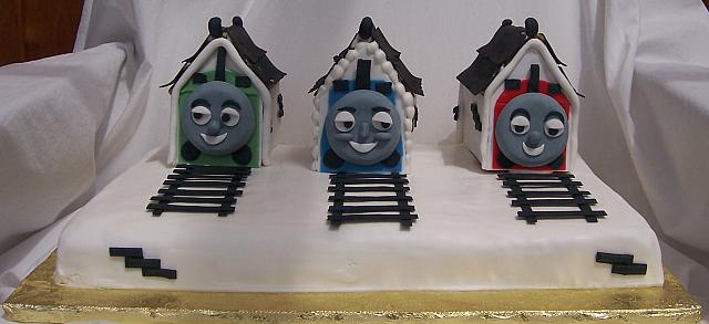 Front view of Thomas the Train cake.  Tracks are made out of edible gumpaste.