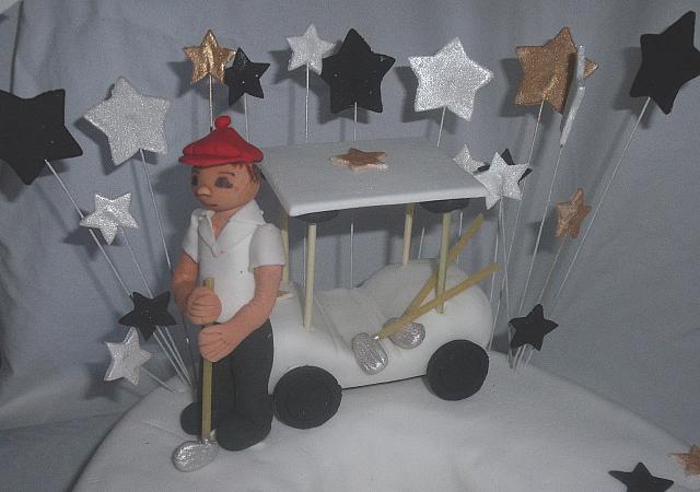 Close up of edible gumpaste golfer, golf cart, and golf clubs