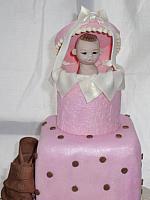 Baby Shower Tiered cake close up of handmade, edible top decoration that is similar to a Precious Moments figurine