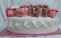 Notice the eyelet tablecloth in this view of Baby Shower Cake with edible bears, rice krispy treat presents, and rice krispy treat purse