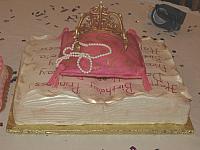 Princess themed cake of fondant covered antique book, edible pillow, and sugarpaste golden crown for baby girl -back view