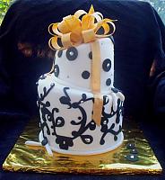 Whimsical Black and White Fondant Cake with Gold Bow and Silver Dragree Accents front view