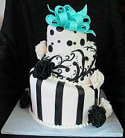 Whimsical Topsy Turvy Black and White Fondant Cake with Teal Bow and Fantasy Flowers