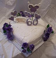 Eileen Perry's Heart shaped birthday cake with sugarpaste purple roses and sugarpaste victorian-themed decorated hearts
