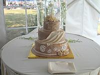 ChampagneOrBeigeIvoryFloralTieredWeddingCakeOnTable