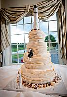 Nautical Theme Ivory Wedding Cake with Fondant Waves,  Edible Lighthouse, Rocks, Gold Shells