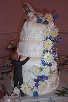 Wedding cake with handmade gumpaste bride and groom, gumpaste horses, gumpaste flowers