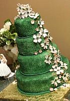 Rich Green Wedding Cake with edible gumpaste dogwood floral spray on each side of cake