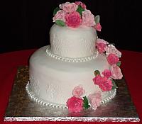 fondant covered wedding cake with multicolored pink sugarpaste roses cascade and edible pearl necklace fondant border